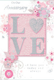 This anniversary card design offers a tender tribute to enduring romance, blending pastel pinks and shimmering silvery greys in a way that feels as intimate as receiving a surprise bouquet at your Norbiton doorstep. At the centre is the word LOVE, formed in softly raised letters, each one brushed with a fine layer of glitter so that it glows without overpowering the rest of the design. The O has been transformed into a silver-textured heart, its surface slightly more reflective, drawing the eye much like a standout bloom in a carefully arranged anniversary bouquet. Around this focal point, delicate clusters of blush and mauve flowers open with a watercolor softness, their edges defined by fine, flowing lines that convey movement and care. Slender curling stems, tiny petals, and a scattering of subtle butterflies weave between the blooms, introducing a gentle sense of whimsy, similar to the light, airy finish a florist might add with trailing foliage or delicate filler flowers. The background is a serene blush pink, deepening just behind the central motif and fading softly toward the outer edges, giving the impression of a gentle halo around the word LOVE. Above and below, the phrases On Our Anniversary and I love you today and always appear in an understated, elegant script, as if handwritten with a steady, affectionate hand. The overall effect is one of softness and sincerity, capturing the quiet joy of shared years and the promise of many more. It feels like the paper companion to an anniversary bouquet thoughtfully prepared and delivered by Flower Delivery Norbiton to celebrate a couple's journey together.
